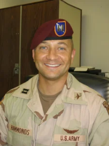 Smiling soldier in uniform with beret.