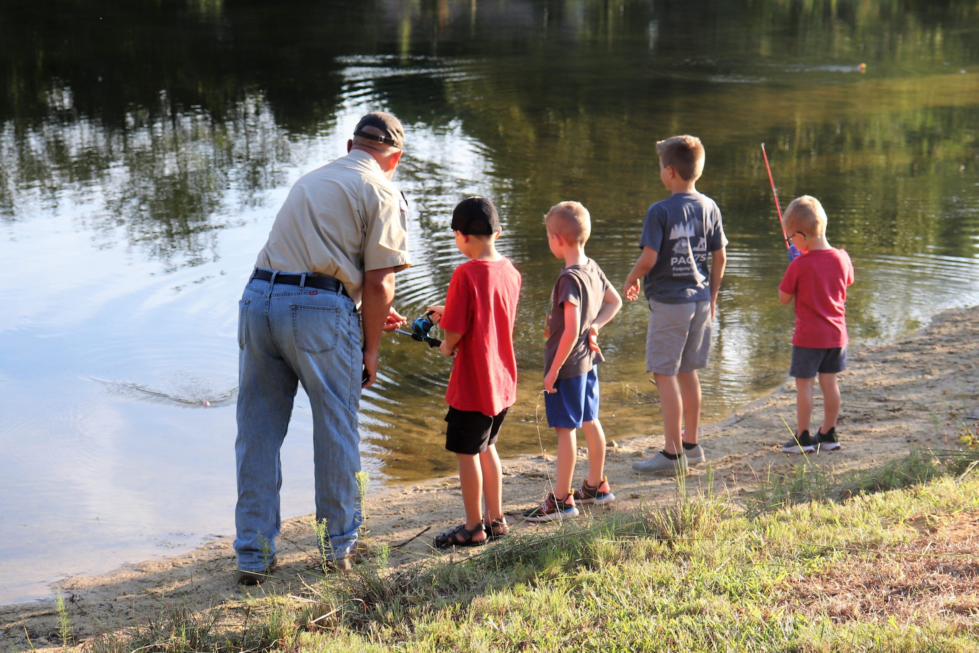 Bear Hammonds, Den Leader, supports Scouts' fishing day on the farm. Alternative Text